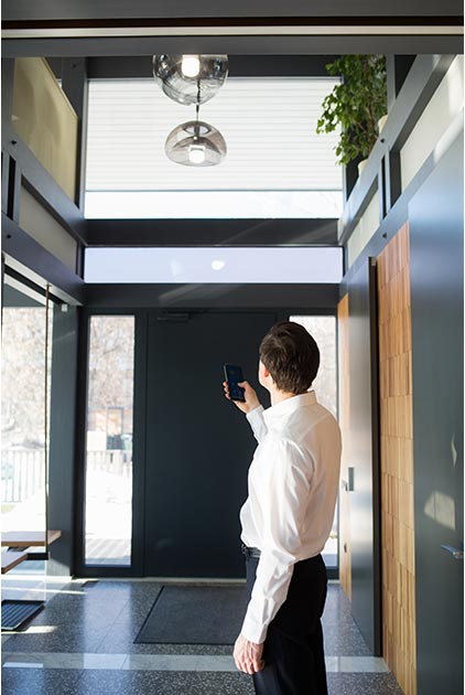 homme qui active une lumière avec son smartphone